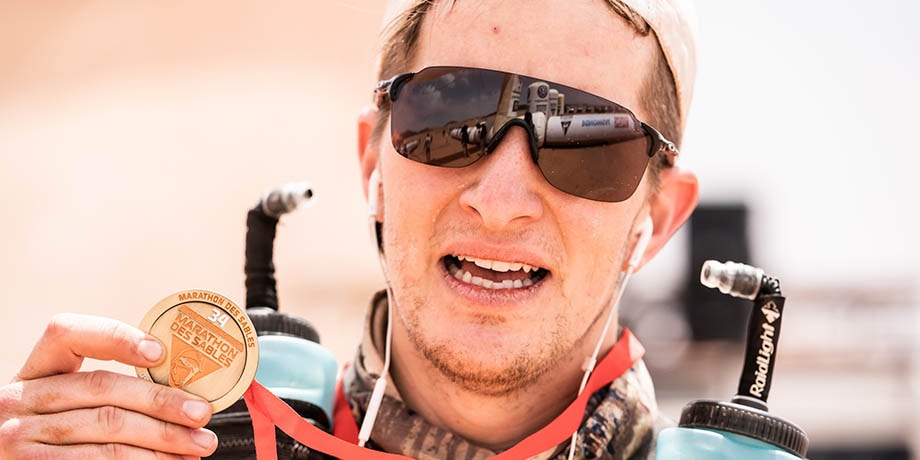 Freddie holding up his finisher medal