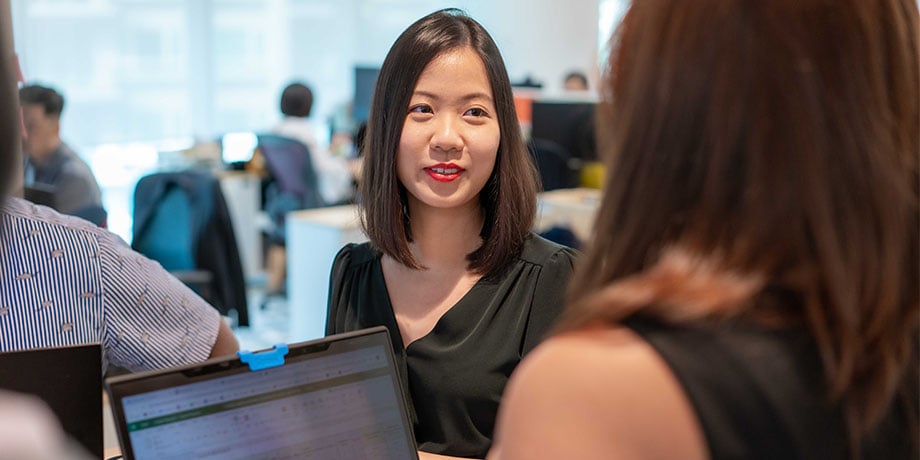 Livia Chng in a discussion at work