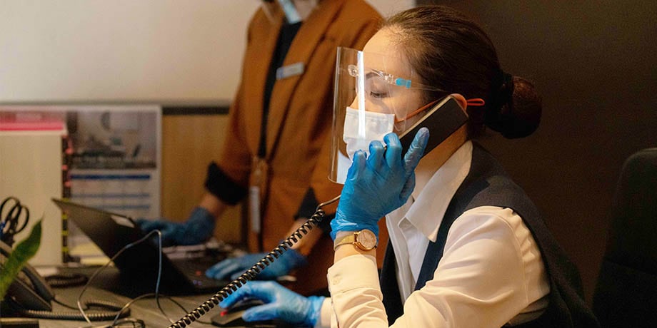 Connect@Changi guest relations ambassador wearing face shield, mask and gloves at work